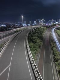 long exposure shot of street at night from high above a freeway junction in new york, new york