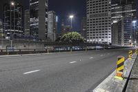 a city street at night with traffic cones and skyscrapers in the background in new york, ny