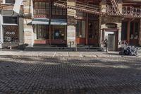 the street is quiet and empty in this city, as well as the bicycles outside
