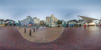 the view of a group of buildings from a fisheye lens on an empty street