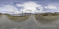 the view from a fish eye lens on a country road and tree lined land in the background