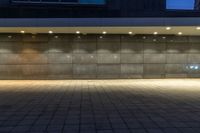 a empty room with concrete walls in it at night, with several spot lights on the floor