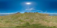 the sun shines brightly on the top of a hill with a person taking a selfie