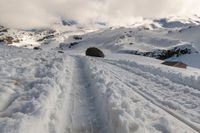 a person on some skis in the snow and mountains below them at least one