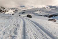 a person on some skis in the snow and mountains below them at least one