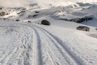 a person on some skis in the snow and mountains below them at least one