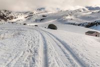 a person on some skis in the snow and mountains below them at least one