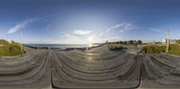 a 3d photograph of a skateboard park on a sunny day near the ocean shore