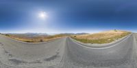 360 - view of a mountain road and a person riding on a bike on top