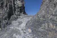 the rock wall has been cut off into two sides and is shown with some rocks on each side