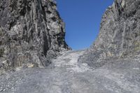 the rock wall has been cut off into two sides and is shown with some rocks on each side