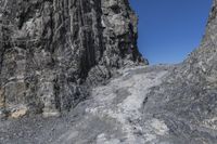 the rock wall has been cut off into two sides and is shown with some rocks on each side