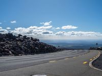 the yellow lines of the road are marking the route to the top of the mountain