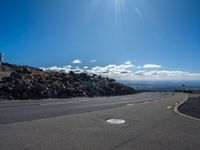 the yellow lines of the road are marking the route to the top of the mountain