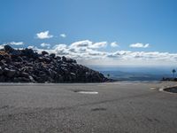 the yellow lines of the road are marking the route to the top of the mountain