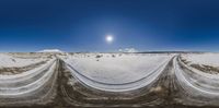 a view of a snow covered field from the ground showing layers of snow, and blue skies