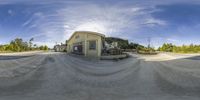 a fish eye lens is seen in the air to view a skate boarder jumping