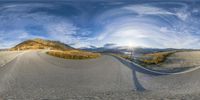 there is a 360 - ray effect in this photo of a winding road and mountains