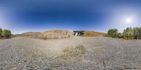 360 - shot photograph of small hill in desert area, from side angle and with blue sky