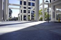 empty plaza with high rise building in the background and floor and sky light on both sides