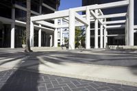 a white and black sign outside of a tall building in california with some palm trees