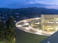 a view of a road and an overpass with traffic passing through it by buildings