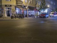 cars and scooters in front of building on night time in city traffic light