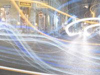 traffic with streaks from a light painting in the foreground and on a road with blurry light