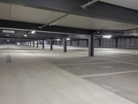 parking spaces at an empty urban parking lot in a city building are lit by high daylights