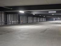 parking spaces at an empty urban parking lot in a city building are lit by high daylights