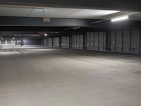 parking spaces at an empty urban parking lot in a city building are lit by high daylights