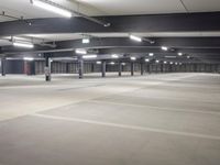 parking spaces at an empty urban parking lot in a city building are lit by high daylights