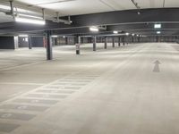 parking spaces at an empty urban parking lot in a city building are lit by high daylights