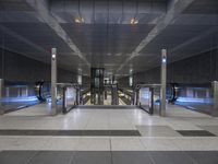 this is the interior of an underground metro station, with escalators and stairs