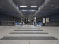 this is the interior of an underground metro station, with escalators and stairs