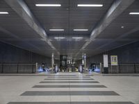 this is the interior of an underground metro station, with escalators and stairs