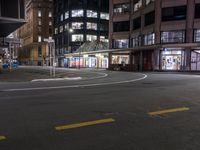 a corner in the city with no one in it at night time and no cars in it