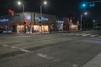 a city intersection with no traffic at night at a coca cola house in the westside