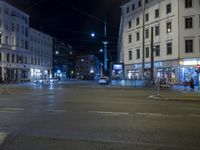 an intersection with a street scene at night in the city with traffic and lights, a few cars on the street