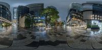 360 lens photo of a street in a city center at night with buildings reflected off the glass walls