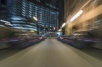 car lights in a blurry city at night on a busy street - image by david evans