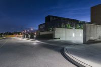 the night has started to show off some architecture in the suburbs of town with the buildings and street light