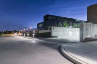 the night has started to show off some architecture in the suburbs of town with the buildings and street light