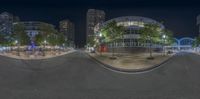 a view of the city from a fisheye lens at night, with a street lined with people