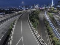 a freeway runs down to the horizon next to a city with many lights in it