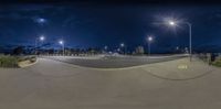 a wide angle view of the street at night with all lights turned on in this time lapsure photo