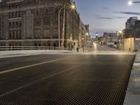 a metal grate is shown at night on the sidewalk in this city street scene