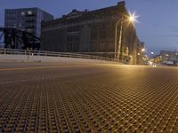 a metal grate is shown at night on the sidewalk in this city street scene