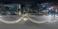 street view with traffic at night and buildings in distance in the background and the camera lens on a tripod