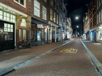 Night Cityscape in Amsterdam with Bicycle and Buildings